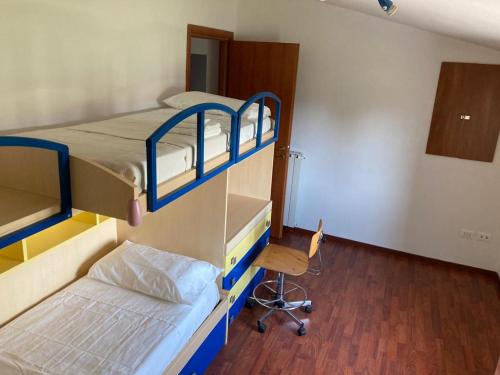 a room with two bunk beds and a chair at V&V Pink House in San Mauro