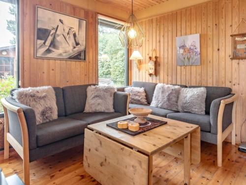 a living room with a couch and a coffee table at 6 person holiday home in Stubbekøbing-By Traum in Stubbekøbing