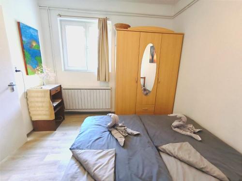 a bedroom with a bed and a dresser and a mirror at Caesar Residence in Budapest