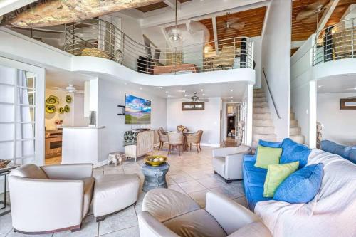 a living room with a couch and a table at The Noniluna Two - Sleeps 9 plus Pack N Play in Lahaina