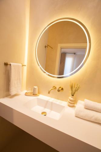 a bathroom with a white sink and a mirror at Alux Boutique Hotel in Málaga
