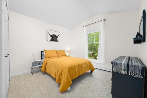 a white bedroom with a bed and a window at Gorogeous Chic 2BDR Renovated Home near Downtown Sleeps 6 843 in Traverse City