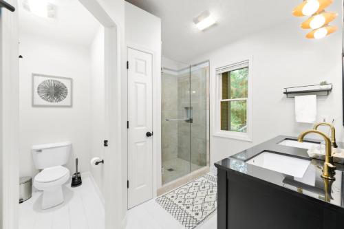 a white bathroom with a sink and a shower at Gorogeous Chic 2BDR Renovated Home near Downtown Sleeps 6 843 in Traverse City