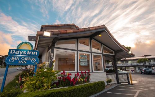 a day inn sign in front of a restaurant at Days Inn by Wyndham Monterey Downtown in Monterey