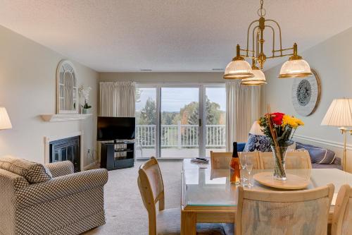 a living room with a dining table and a living room with a fireplace at Beautiful Comfy 2 Bedroom Condo Stunning Golf Course Views 5166 in Traverse City