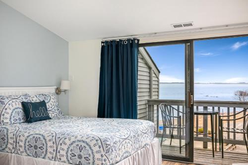 a bedroom with a bed and a view of the ocean at Beautiful Bay View Couples Retreat at The Shores 5586 in Traverse City
