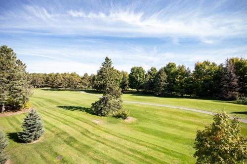 an aerial view of a golf course with trees at Beautiful 2BDR Loft Suite at Golf Course Condo 5549 in Traverse City