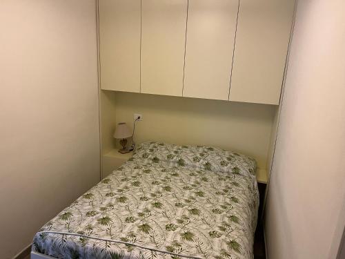 a small bedroom with a bed and cabinets at Casa Filippini in Bologna