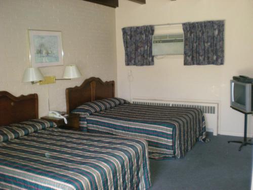 Postel nebo postele na pokoji v ubytování Motel Seigneurie de Vaudreuil