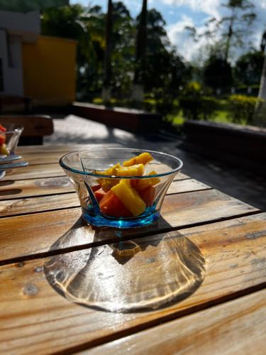 a glass bowl of fruit on a wooden table at Hotel Casa Confort in Santa Rosa de Cabal