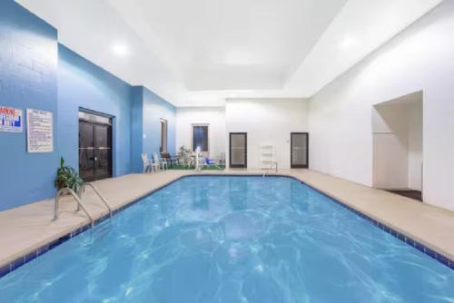 a pool in a hotel room with blue walls at Winston Salem Inn & Suites in Winston-Salem