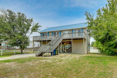 a house with a staircase in front of it at Coastal Emerald Isle Retreat with Deck and Grill! in Emerald Isle