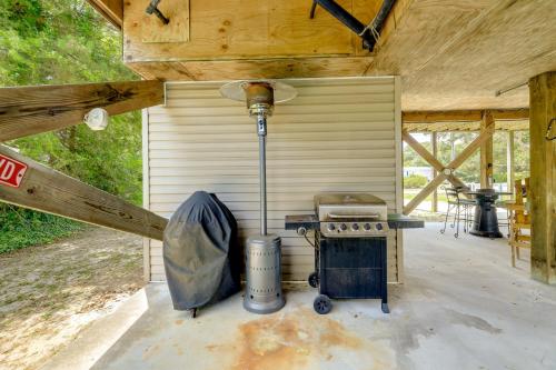 an outdoor kitchen with a stove in a shed at Coastal Emerald Isle Retreat with Deck and Grill! in Emerald Isle