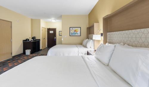 a hotel room with two beds with white sheets at Holiday Inn Hotel & Suites Waco Northwest by IHG in Bellmead