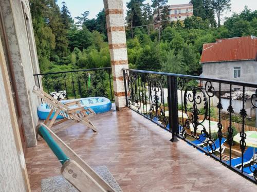 a balcony with a bench and a view at Guest House Dimitri in Chakvi