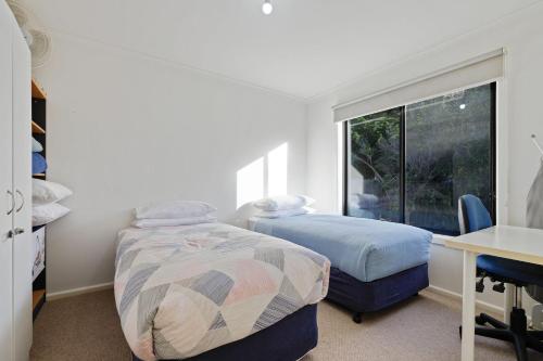 A bed or beds in a room at Broadwater Coastal Cottage