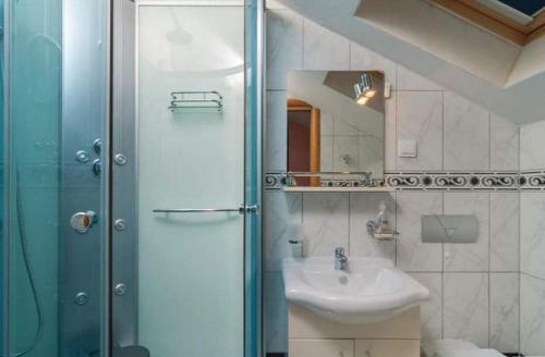 a bathroom with a sink and a shower at Luxury villa with a swimming pool Skrip, Brac - 17350 in Postira