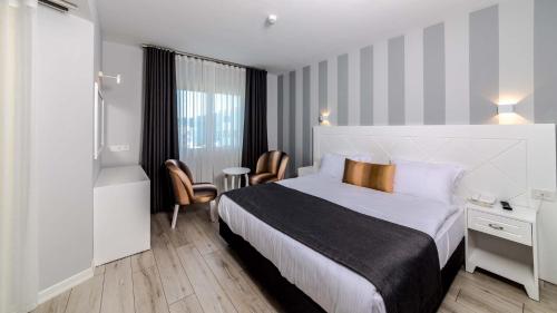 Ένα ή περισσότερα κρεβάτια σε δωμάτιο στο Motto Premium Hotel&Spa