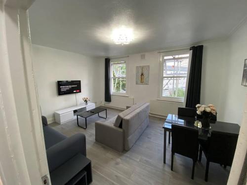 a living room with a couch and a table at 2 Bedroom Flat in London in London