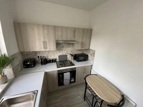 a kitchen with a sink and a stove top oven at 2 Bedroom Flat in London in London