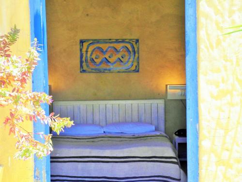 a bedroom with a bed with a blue frame at Patio De La Luna in Asilah