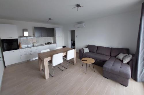 a living room with a couch and a table at Apartments with parking space Borje, Peljesac - 21496 in Orebić