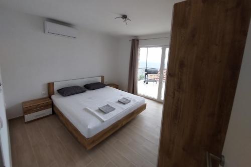 a bedroom with a bed and a sliding glass door at Apartments with parking space Borje, Peljesac - 21496 in Orebić