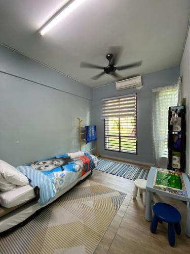 een slaapkamer met een bed en een plafondventilator bij Homestay Hana Senawang in Seremban