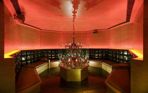 a dining room with a chandelier in the middle at The LaLiT New Delhi in New Delhi