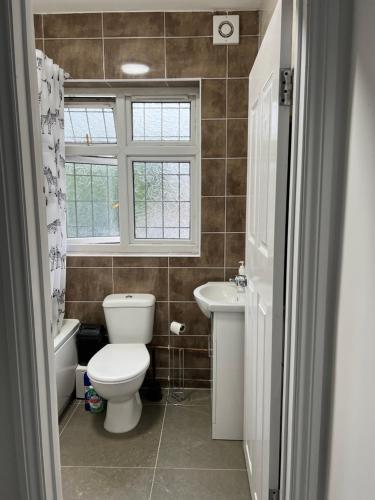 a bathroom with a toilet and a sink at Starlet Property in Wanstead