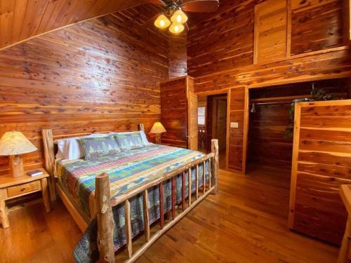 a bedroom with a bed in a log cabin at Chalet with a view at Bear Mountain - Hottub in Eureka Springs
