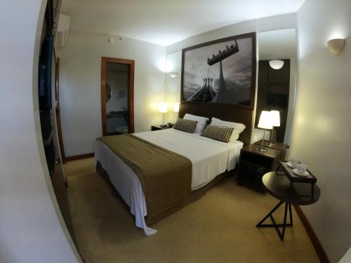 a bedroom with a large bed in a room at Bonaparte Hotel - Excelente Apartamento #1402 in Brasilia