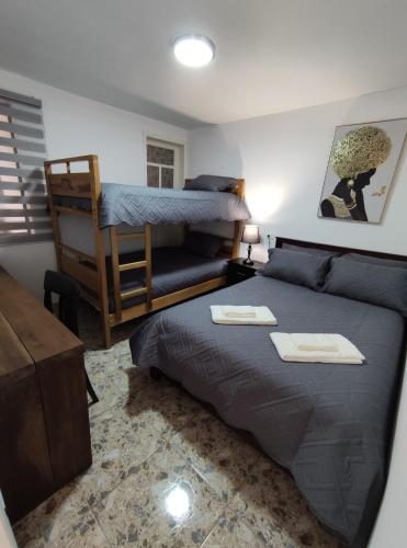 a bedroom with a bed and a bunk bed at "Apartamento Blanco" en Centro de Baños in Baños