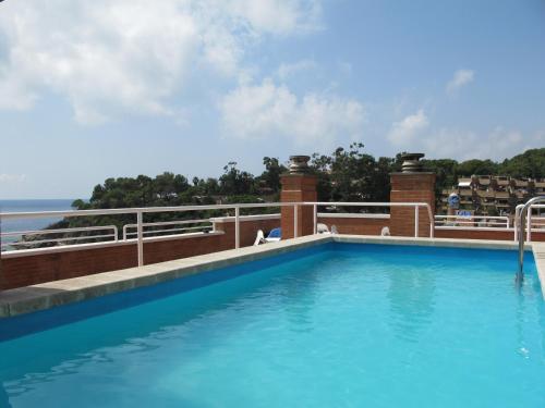 a swimming pool on the roof of a building at Apartaments Rosanna in Lloret de Mar