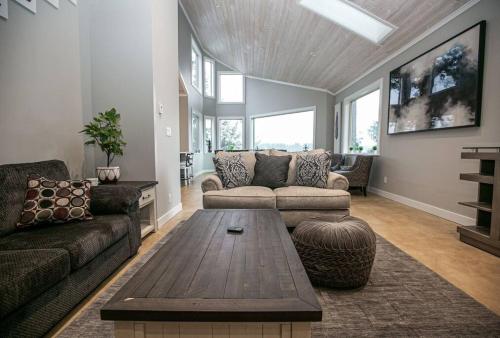 a living room with a couch and a coffee table at Water Front Home with Private Dock and Hottub in Sooke