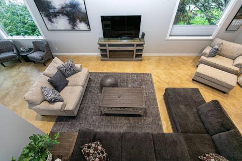 a living room with two couches and a tv at Water Front Home with Private Dock and Hottub in Sooke