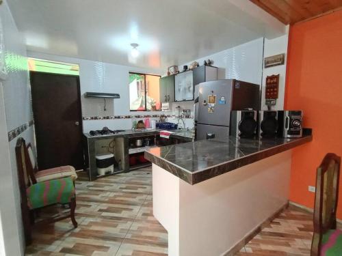 a kitchen with a counter and a refrigerator at Casa en Guasca in Guasca