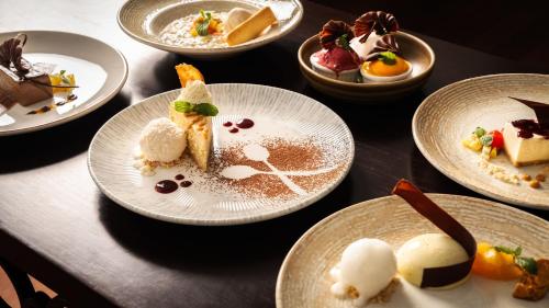 a table with plates of desserts on it at Grand Pacific Hotel in Suva
