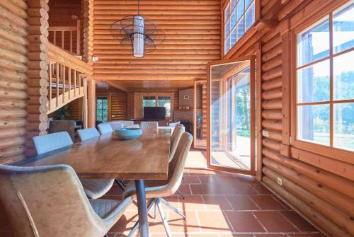 ein Esszimmer mit einem Holztisch und Stühlen in der Unterkunft Beach & Golf Retreat w Amazing pool, By TimeCooler in Aroeira