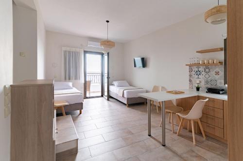 a kitchen and living room with a table and a couch at Costa Mare in Paralia Vrachou