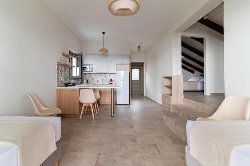 a kitchen and living room with two beds and a table at Costa Mare in Paralia Vrachou