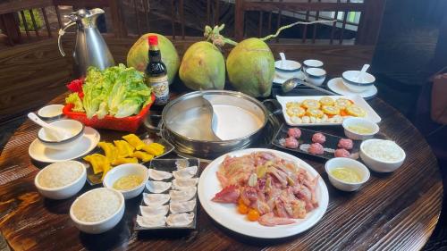 a table with plates of food on a table at Ramada Foshan Hotel in Foshan