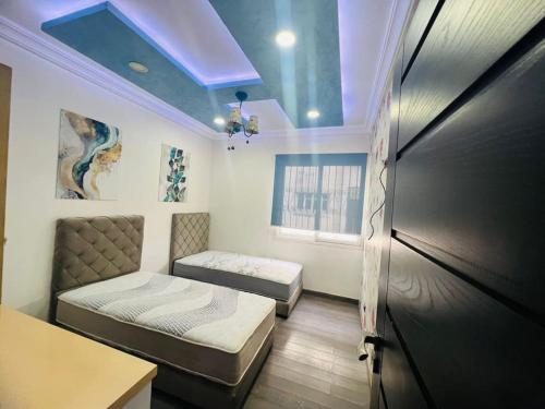 เตียงในห้องที่ Calm Apartment in Mazola next to Aeria Mall & Casa Finance City
