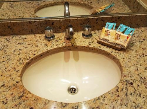 a bathroom sink with a faucet and toothpaste at Hotel Bristol Asuncion in Asunción