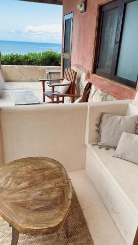 a living room with a couch and a coffee table at La Conchita Tulum in Tulum