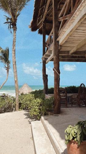 a porch of a resort with a view of the beach at La Conchita Tulum in Tulum