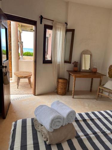 a bedroom with two towels sitting on a bed at La Conchita Tulum in Tulum