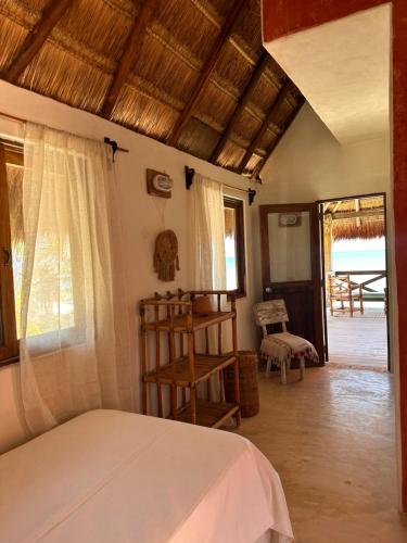 a bedroom with a bed and a view of a patio at La Conchita Tulum in Tulum