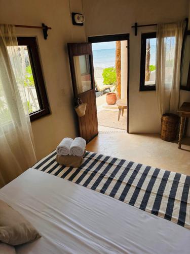 a bedroom with a bed with towels on it at La Conchita Tulum in Tulum