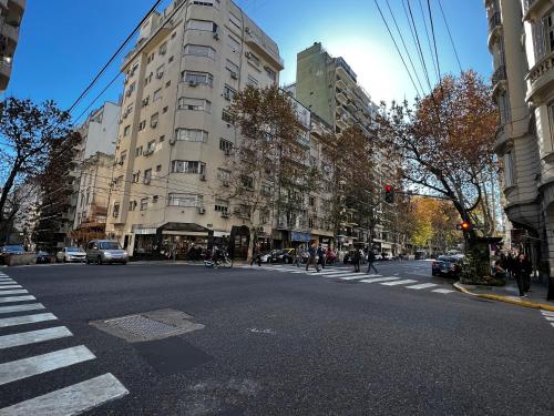 een drukke straat met gebouwen en mensen die de straat oversteken bij Premium Apartments in Barrio Norte by Apartments Bariloche in Buenos Aires